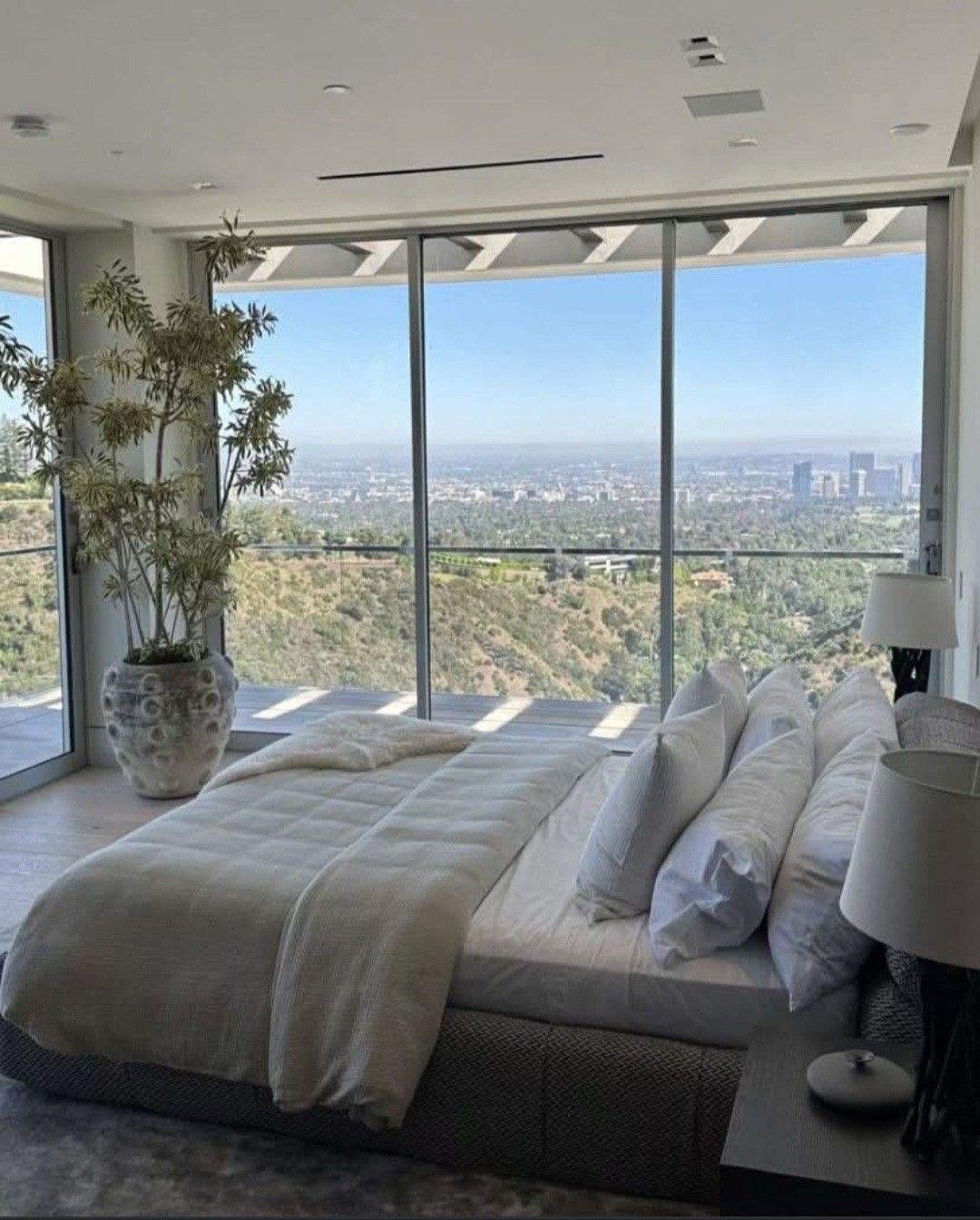 Spotless Scrubbers team member preparing Airbnb bedroom with fresh towels in Los Angeles