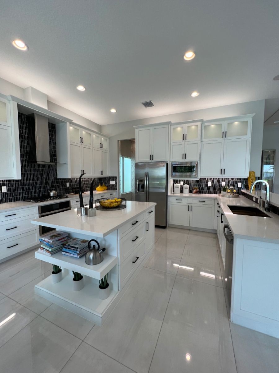 Professional cleaner scrubbing kitchen sink during deep clean in Los Angeles